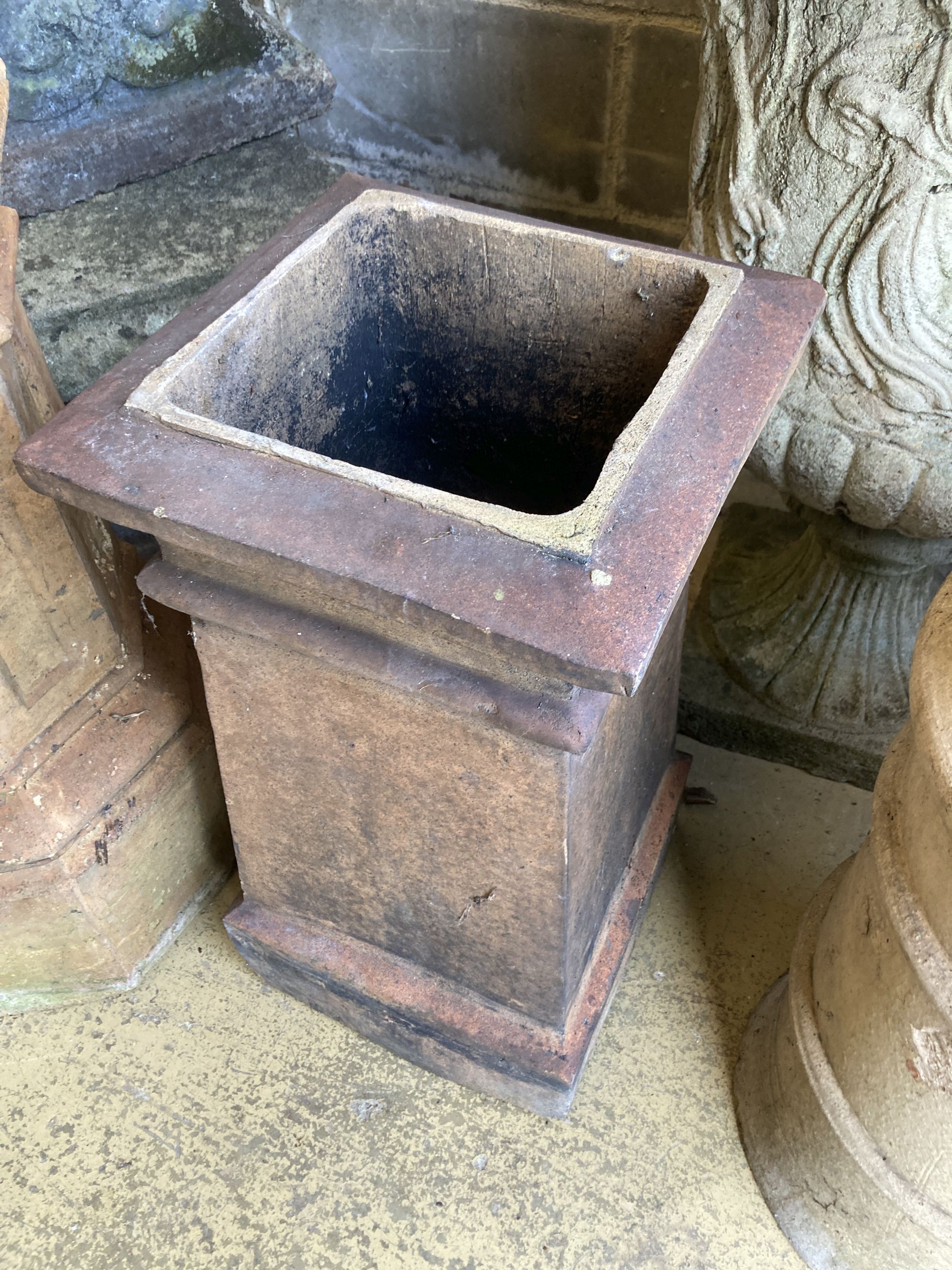 A terracotta chimney pot and another, larger 72cm high